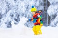 Child making snowman. Kids play in snow in winter Royalty Free Stock Photo