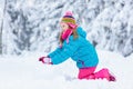 Child making snowman. Kids play in snow in winter Royalty Free Stock Photo