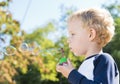 Child making soap bubbles outside Royalty Free Stock Photo