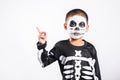 Child man horror face painting make up for ghost scary point finger to side space Royalty Free Stock Photo