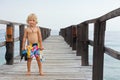 Child with mask, fins going to snorkel in tropical sea Royalty Free Stock Photo