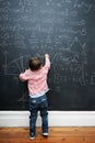 Child, math and blackboard with writing in classroom for knowledge, development and young genius in school. Kid, numbers Royalty Free Stock Photo