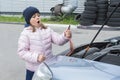 A child mechanic is repairing a battery in a car. Car repair