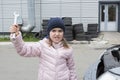 Child mechanic with a wrench on the background of the garage. Close-up. Auto repair concept