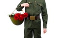 Child in military uniform, holding in his hand a hard hat with carnations, on a white background