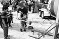 Child minder assisting a boy to hit a strength tester at outdoor