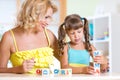 Child and mom playing wooden toys at home Royalty Free Stock Photo