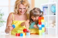 Child and mom playing wooden toys at home Royalty Free Stock Photo