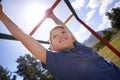 Child, monkey bars and energy on playground, smiling and obstacle course on outdoor adventure at park. Happy male person