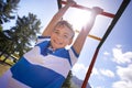 Child, monkey bars and park in portrait, smiling and energy at obstacle course on outdoor adventure. Happy male person