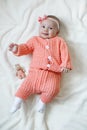 A child of 5 months is having fun alone,lying on a snow-white bed. Royalty Free Stock Photo