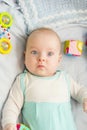 Child 3 months old lies alone in bed Royalty Free Stock Photo