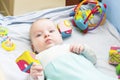 Child 3 months old lies alone in bed Royalty Free Stock Photo