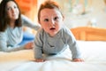 Child and mother on bed. Mom and baby boy playing in sunny bedroom. Parent and little kid relaxing at home. Family having fun Royalty Free Stock Photo