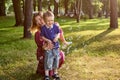 Child with mother blows soap bubble outside. Royalty Free Stock Photo