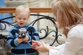 Child and mother. Boy examines photo with camera Royalty Free Stock Photo