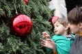 Child with mother at christmas tree Royalty Free Stock Photo