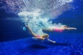 Child with mother dive in swimming pool Royalty Free Stock Photo