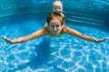 Child with mother dive in swimming pool Royalty Free Stock Photo