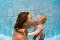 Child with mother dive in swimming pool Royalty Free Stock Photo