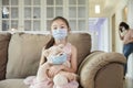 Child and mother in medical masks while coronavirus quarantined at home