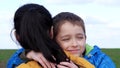 The child and the mother. Mother's Day. A happy family in the open air. Cute boy hugs his mom. Happy childhood. Portrait