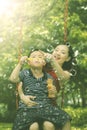 Child with mother playing soap bubbles in park Royalty Free Stock Photo