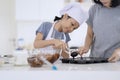 Child and mother preparing chocolate dough