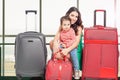 Child with mother ready to travel. Airport terminal. Royalty Free Stock Photo