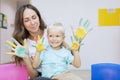 Child and mother showing painted palms Royalty Free Stock Photo