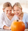 Child, mother and smile with pumpkin to celebrate halloween party together at home. Happy young girl, mom and family Royalty Free Stock Photo