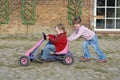 Child moves pedal car