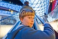 Child on moving staircase looks self confident Royalty Free Stock Photo