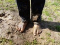 Child with muddy feet and mud and grass Royalty Free Stock Photo