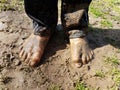 Child with muddy feet and mud and grass Royalty Free Stock Photo