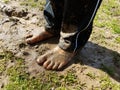 Child with muddy feet and mud and grass Royalty Free Stock Photo