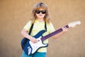 Child musician guitarist playing electric guitar. Music kids. Royalty Free Stock Photo