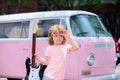 Child musician holding guitar and walking in city. Rock, pop kids music. Royalty Free Stock Photo