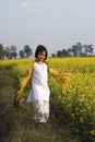An Indian child and mustard flower Royalty Free Stock Photo