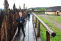 Child next to wooden palisade of viking village