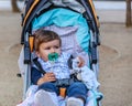 A child observes sitting in his baby carriage