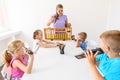 Child occupational therapy session. Group of children doing playful exercises with their therapist. Learning difficulty concept. Royalty Free Stock Photo