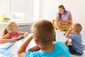 Child occupational therapy session. Group of children doing playful exercises with their therapist. Learning difficulty concept. Royalty Free Stock Photo