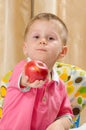 Child offering an apple Royalty Free Stock Photo