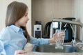 Child open water tap. Kitchen faucet. Glass of clean water. Pouring fresh drink. Hydration. Healthy lifestyle. Water quality check Royalty Free Stock Photo