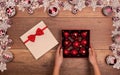 Child opening christmas present with red baubles Royalty Free Stock Photo