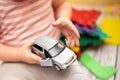 Child opens door to gray minivan. development of fine motor skills in children. Games in kindergarten. Royalty Free Stock Photo