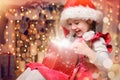 Child opens a New Year`s gift. Happy girl. Christmas miracle Royalty Free Stock Photo