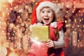 Child opens a New Year`s gift. Happy girl. Christmas miracle Royalty Free Stock Photo