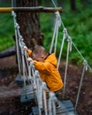 Child with orange jacket enjoys playground activities Royalty Free Stock Photo